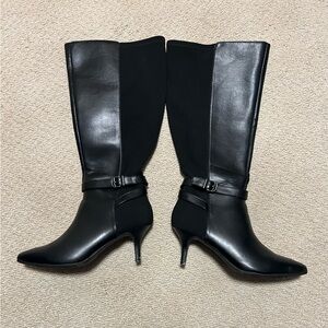 Long black boots, size 7. Man-made fabric stretchy fabric in back. Worn once.